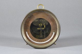 A circular aneroid barometer contained in a gilt metal case by J C Vickery 5"