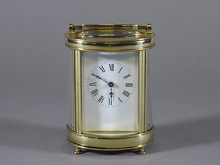 A 19th Century French oval carriage clock with enamelled dial contained in a gilt metal case
