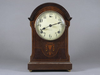 An Edwardian Continental striking mantel clock with enamelled  dial and Arabic numerals contained in an arch shaped inlaid  mahogany case