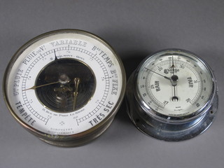 A circular aneroid barometer with paper dial contained in a chrome case 4 1/2" together with a French aneroid barometer  contained in a chrome case 5"