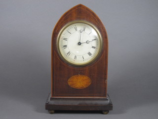 A bedroom timepiece with enamelled dial and Roman numerals  contained in an inlaid mahogany shaped case