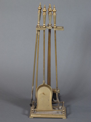 A brass 4 piece fireside companion set comprising brush, poker,  tongs and shovel