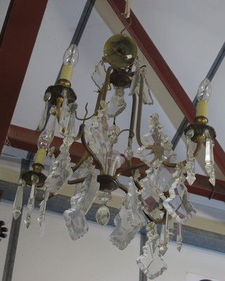 A gilt metal 4 light electrolier hung glass lozenges