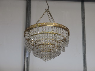 A circular 4 tier gilt metal light fitting hung lozenges
