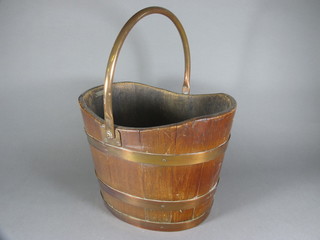 An oval coopered oak coal bucket with swing handle 15"w x  11"d x 10"h