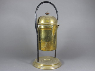 A curious cylindrical copper kettle raised on a brass and iron  stand