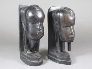 A pair of carved African bookends in the form of portrait busts  9"