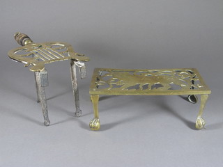 A rectangular pierced brass footman decorated a tiger 10"  together with a lyre shaped trivet