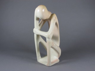 A Henry Moore style carved marble figure of a seated man 14"