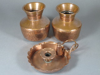 A circular copper chamber stick, base marked J S & S 6" together with a pair of circular planished copper vases 5"