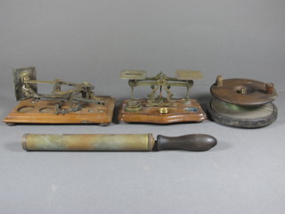 A large wooden centre pin fishing reel 5 1/2", 2 pairs of letters scales - 1f and a small brass syringe