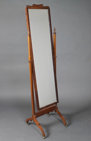 A cheval mirror contained in a walnut frame 16"w x 64"h