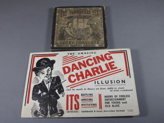The Amazing Dancing Charlie Chaplin figure together with a  travel set of ivory draughts
