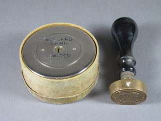 A circular Midland Bank money box and a Midland Bank brass  seal marked 76 High Street Epsom