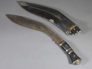 A Kukri with 12" blade, corroded, complete with leather  scabbard and 2 skinning knives