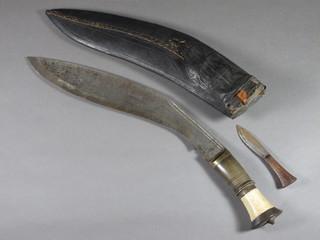 A Kukri with 11 1/2" blade complete with leather scabbard