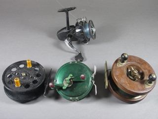 A wooden and mahogany Starback fishing reel 3", a WR  Speedier fishing reel 4", a metal centre pin fishing reel 3" and an  Intrepid Extra fishing reel