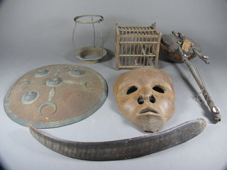 A circular Eastern shield 14", a wooden cage 6", a mask etc