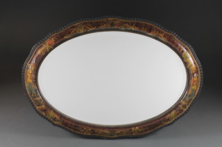 A 1930's oval bevelled plate wall mirror contained in a chinoiserie style frame 35" x 24"