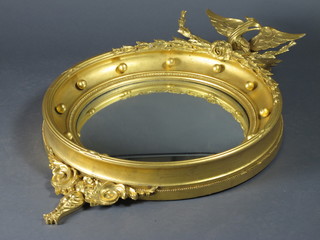 A Regency circular convex plate wall mirror contained in a ball studded frame surmounted by an eagle 24"