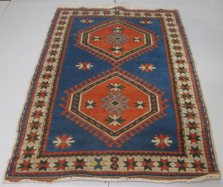 A blue ground Afghan rug with 2 octagons to the centre within  multi-row borders 85" x 54"
