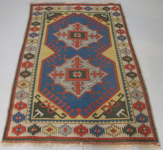 A contemporary blue and yellow ground Afghan rug with 2  octagons to the centre within multi-row borders 81" x 52"