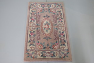 A cream ground and floral patterned Chinese rug 48" x 27"