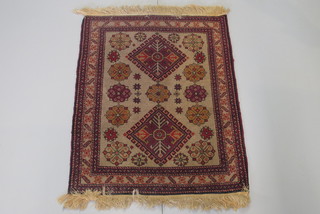 A brown ground Eastern rug with 2 diamonds to the centre 34" x  25"
