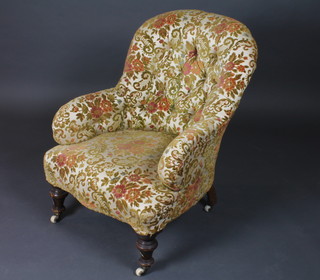 A Victorian armchair upholstered in sculptured yellow material