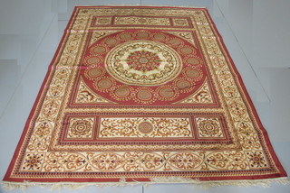 A gold coloured Aubusson style rug with central medallion 110"  x 80"