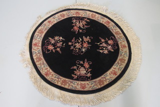 A circular black ground and floral patterned Chinese rug 36"