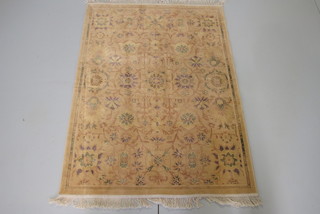 A gold ground and floral patterned cotton rug 55" x 39"
