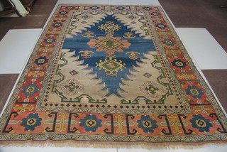 A blue and white ground Eastern rug with stylised diamond to the centre 137" x 93"