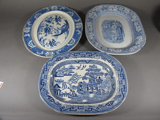 A 19th Century blue and white Willow pattern meat plate 16", cracked, a 19th Century blue and white meat plate decorated an  interior scene with fountain 18" - chipped, an Aguila meat plate  decorated a bird 18"