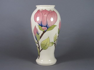 A white glazed Moorcroft vase decorated Magnolia, the base  impressed Moorcroft and with bell mark, 12"  ILLUSTRATED