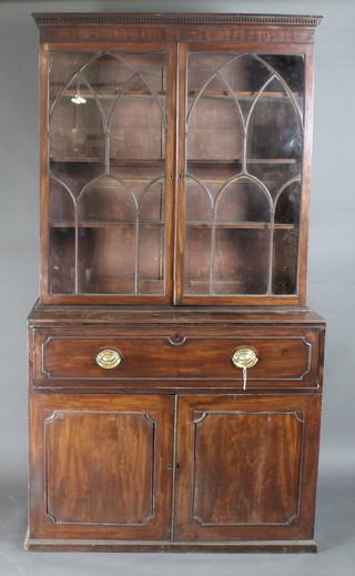 A Georgian mahogany secretaire bookcase the upper section with moulded and dentil cornice, the shelved interior enclosed by  astragal glazed panelled doors, the base fitted a well fitted  secretaire drawer above a double cupboard fitted trays 48"w x  24"d x 90"h