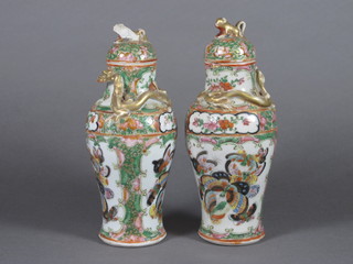 A pair of 19th Century Canton famille rose porcelain urns and covers 6" - 1 with chip to rim, 1 lid chipped