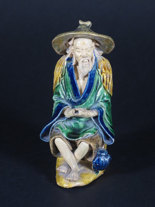An Oriental figure of a seated fisherman 6"