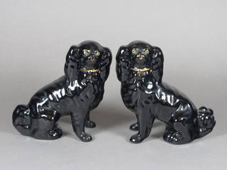A pair of Staffordshire black glazed figures of seated Spaniels 6"