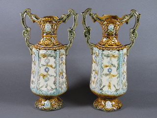 A pair of Majolica style twin handled urns 11"
