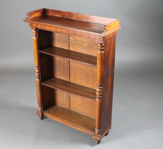 A Victorian style mahogany bookcase with three-quarter gallery fitted shelves and raised on turned supports 27"w x 9"d x 37"h