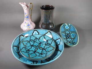 A Persian style circular blue glazed bowl 13", 2 do. plates 11", a  boat shaped dish 11", a Lancastrian pottery vase 9" and a pink  glazed jug