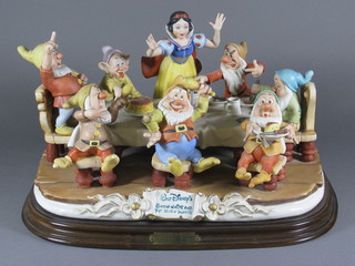 A limited edition Capodimonte figure group - Snow White and  the Seven Dwarfs, raised on a wooden base 17"