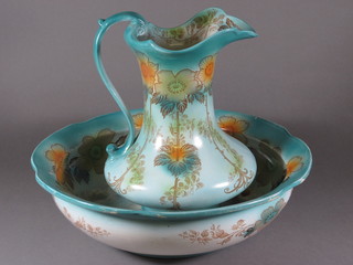 An Art Nouveau green and floral patterned jug and bowl set