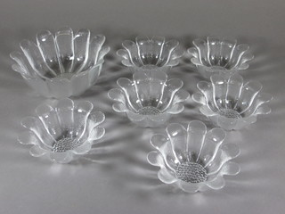 A 7 piece Dartington glass fruit service of flower head form comprising bowl 8 1/2" and 6 dishes 6"