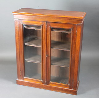 A Victorian walnut bookcase fitted adjustable shelves and enclosed by glazed panelled doors 35"w x 12"d x 42"h