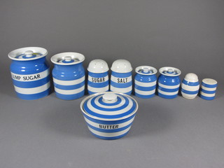 A T G Green Cornish Kitchenware blue and white banded storage jar and cover marked Lump Sugar, the base with brown shield  mark 5 1/2", do. cylindrical jar marked Spice 3", a plain storage  jar the base with green shield mark 5", 2 sugar sifters, a salt and  pepper and a circular bowl marked Butter