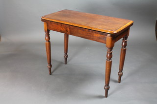 A Victorian mahogany D shaped card table, raised on turned supports 36"w x 18"d x 29"h