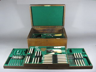 A part canteen of silver plated Old English flatware by Walker & Hall contained in an oak canteen box