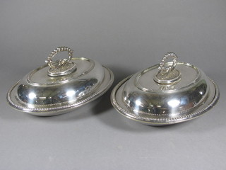 A pair of oval silver plated entree dishes and covers